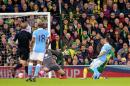 Manchester City's Sergio Aguero, right, scores his side's first goal of the match during their English FA Cup, third round soccer match against Norwich City at Carrow Road, Norwich, England, Saturday, Jan. 9, 2016. (Chris Radburn/PA via AP) UNITED KINGDOM OUT - NO SALES - NO ARCHIVES