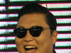 South Korean rapper PSY, who sings the popular "Gangnam Style," smiles while greeting Thai fans during a press conference in Bangkok, Thailand, Wednesday, Nov. 28, 2012. PSY will perform in Thailand on Wednesday night -  his first show in Asia outside of South Korea.  (AP Photo/Sakchai Lalit)