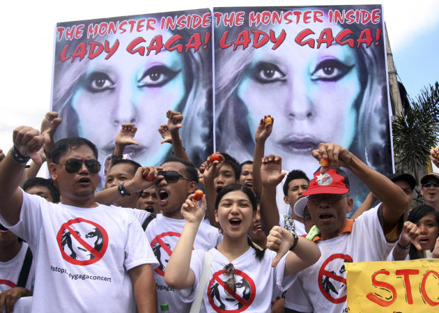 Members of a religious group give thumbs-down signs as they shout "Stop Lady Gaga Concert" during a rally near the venue of the pop diva's upcoming concert Saturday, May 19, 2012 in suburban Pasay, south of Manila, Philippines. They said they were offended by her music and videos, in particular her song "Judas," which they say mocks Jesus Christ. (AP Photo/Pat Roque)