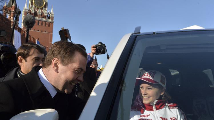 Russia&#39;s Prime Minister Medvedev and figure skating gold medal winner Lipnitskaya attend ceremony to present automobiles to the Sochi 2014 Winter Olympics prize-holders representing Russia, in central Moscow