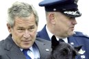 File photo of U.S President George W. Bush grabbing one of the paws of Barney the presidential dog, to wave to the press upon his arrival at Andrews Air Force Base