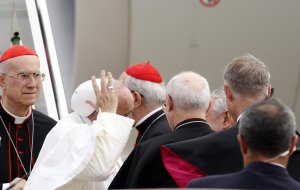 Pope Francis, holds his skull cap as he is welcomed …