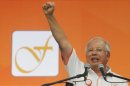 Malaysia's Prime Minister Najib Razak shouts at the end of his speech to farmers at Felda Jengka 8 plantation, near town of Jerantut