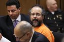 Ariel Castro looks over at the prosecutors table during court proceedings Friday, July 26, 2013, in Cleveland. Castro, who imprisoned three women in his home, subjecting them to a decade of rapes and beatings, pleaded guilty Friday to 937 counts in a deal to avoid the death penalty. In exchange, prosecutors recommended Castro be sentenced to life without parole plus 1,000 years. (AP Photo/Tony Dejak)