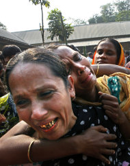 Relatives of garment factory workers killed in a fire cry as they come to collect bodies from a mortuary in Dhaka, Bangladesh,   Sunday,
 Nov. 25, 2012. At least 112 people were killed in a late Saturday night fire that raced through the multi-story garment
 factory just outside of Bangladesh's capital, an official said Sunday. (AP Photo/Khurshed Rinku)