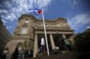 Guard stands in front of the new Cuban embassy in Washington after officials raised the national flag in a ceremony