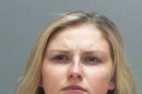 This photo released by the Salt Lake County Jail shows Kendra McKenzie Gill, who was arrested with three others on Saturday Aug. 3, 2013, after allegedly throwing homemade bombs from her car. Gill was recently crowned Miss Riverton, Utah. (AP Photo/Salt Lake County Jail)