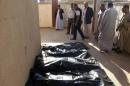 Bodies of victims killed in a suicide attack that tore through a residential area of Al-Muwaffaqiyah, a village east of Mosul, are lined up for identification at a hospital in the northern Iraqi city on October 17, 2013