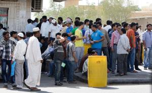 Foreign workers gather outside the Saudi immigration …