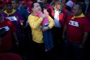 Venezuela's President Hugo Chavez embraces a girl during a campaign rally in Guarenas, Venezuela, Saturday, Sept. 29, 2012. Venezuela's presidential election is scheduled for Oct. 7. (AP Photo/Rodrigo Abd)