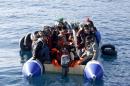 Refugees and migrants are seen on a dinghy as they approach the Ayios Efstratios Coast Guard vessel, during a rescue operation at open sea between the Turkish coast and the Greek island of Lesbos