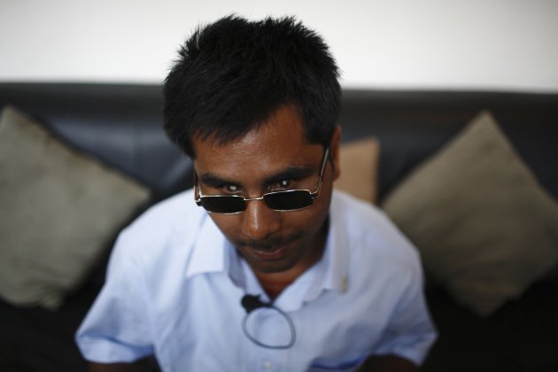 Jha, one of the visually impaired waiters at Nepal&#39;s first blind restaurant, sits on a couch as he listens to instructions at the restaurant in Kathmandu