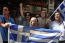 Protesters shout slogans outside the Finance Ministry in Athens