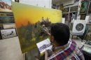 Iraqi artist Ahmed al-Khazali paints in his workshop at a gallery in Baghdad's Karrada district