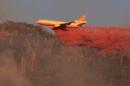 A fire fighting aircraft drops fire retardant over wildfire in Kern County in central California