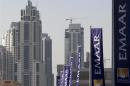 Flags for property company EMAAR, builders of Burj Dubai the world's tallest tower, are seen in Dubai