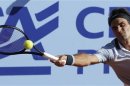 Switzerland's Roger Federer returns the ball to Germany's Daniel Brands during their Swiss Open second round tennis match in Gstaad