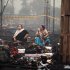 Indian eunuchs sit at the scene of a fire at a fairground in New Delhi, India, Monday, Nov. 21, 2011. The blaze, which killed more than a dozen people, happened during a gathering of thousands of eunuchs at a prayer ceremony and feast held once every five years at a fairground in the Nandnagary neighborhood of east Delhi. (AP Photo/Kevin Frayer)