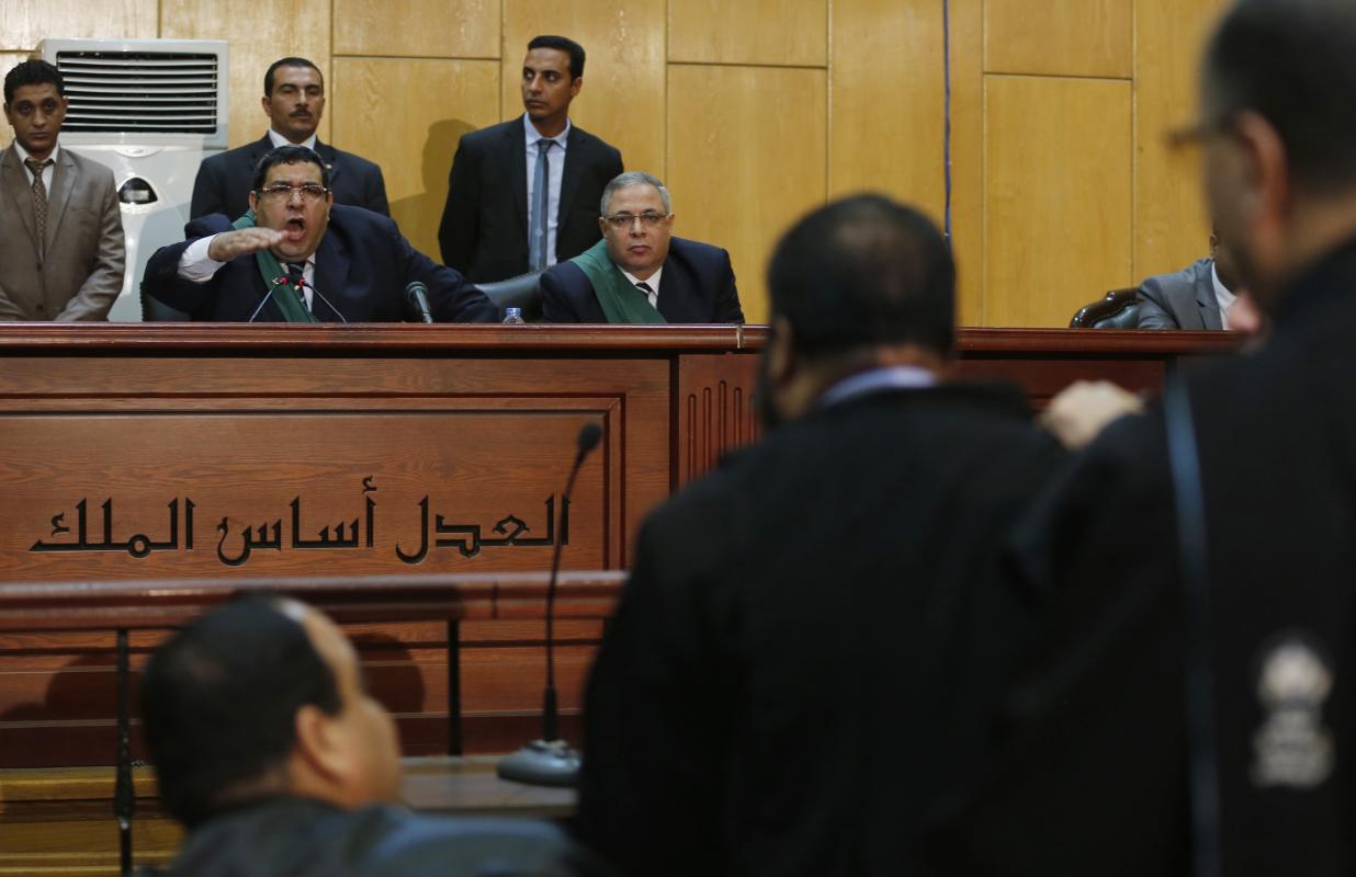 Head of the Cairo Criminal Court argues with lawyers during the trial of ousted Egyptian President Mursi and other leaders of the Brotherhood on charges of spying and terrorism at a court in the police academy on the outskirts of Cairo