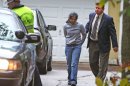 Annie Dookhan, center, is escorted to a cruiser outside her home in Franklin, Mass., Friday, Sept. 28, 2012. Dookhan is accused of faking drug results, forging signatures and mixing samples a state police lab. State police say Dookhan tested more than 60,000 drug samples involving 34,000 defendants during her nine years at the lab. Defense lawyers and prosecutors are scrambling to figure out how to deal with the fallout. (AP Photo/Bizuayehu Tesfaye)