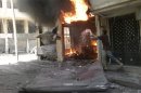A fire burns after a shelling at Juret al-Shayah in Homs city