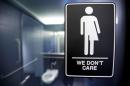 A sign protesting a recent North Carolina law restricting transgender bathroom access adorns one of the stalls at the 21C Museum Hotel in Durham, North Carolina