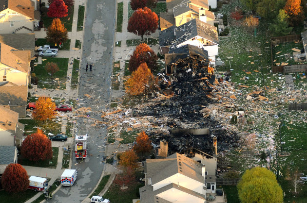 This aerial photo shows the two homes that were leveled and the numerous neighboring homes that were damaged from a massive explosion that sparked a huge fire and killed two people, Sunday, Nov. 11, 2012, in Indianapolis. Nearly three dozen homes were damaged or destroyed, and seven people were taken to a hospital with injuries, authorities said Sunday. The powerful nighttime blast shattered windows, crumpled walls and could be felt at least three miles away. (AP Photo/The Indianapolis Star, Matt Kryger) NO SALES