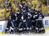 The Yale bench piles on right wing Andrew Miller to celebrate his game-winning overtime goal against UMass Lowell during an NCAA Frozen Four college hockey semifinal in Pittsburgh on Thursday, April 11, 2013. Yale won 3-2. (AP Photo/Gene J. Puskar)