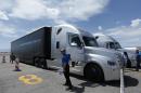 People load in to a Daimler Freightliner Inspiration self-driving truck for a demonstration Wednesday, May 6, 2015, in Las Vegas. Although much attention has been paid to autonomous vehicles being developed by Google and traditional car companies, Daimler believes that automated tractor-trailers will be rolling along highways before self-driving cars are cruising around the suburbs. (AP Photo/John Locher)