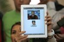 Lawyer Guerrero holds up a tablet to show a combination of photos of her client Beltran during a news conference in Guadalajara