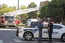 Police block the road in front of an apartment where the suspect in a theatre shooting lived in Aurora, Colo., on Friday, July 20, 2012. As many as 12 people were killed and 50 injured at a shooting at the Century 16 movie theatre on Friday. The suspect is identified as 24-year-old James Holmes. (AP Photo/Ed Andrieski)