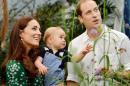 Photo taken on July 2, 2014 to mark the first birthday of Britain's Prince George shows Prince William (R) and Kate, Duchess of Cambridge with George during a visit to the Natural History Museum in London