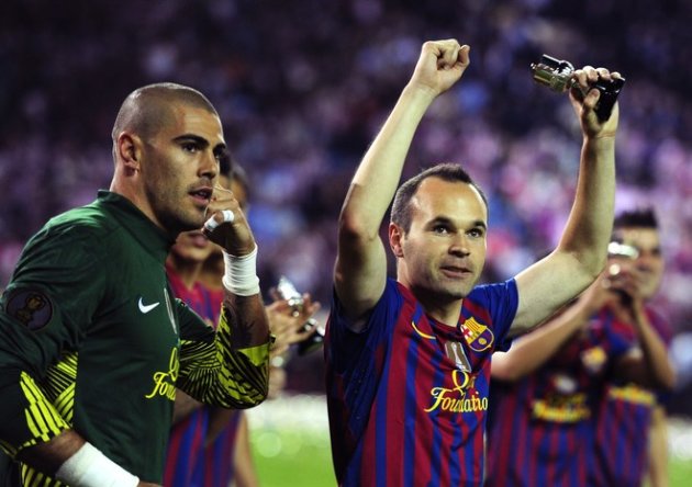 Barcelona's Goalkeeper Victor Valdes (L) And Barcelona's Midfielder Andres Iniesta (R) Celebrate Their Team's Victory AFP/Getty Images