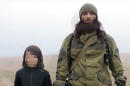 Picture released by Al-Hayat Media Centre claims to show an Islamic State group fighter next to a child, before the child executes two men (AFP IS NOT RESPONSIBLE FOR ANY DIGITAL ALTERATIONS TO THE PICTURE'S EDITORIAL CONTENT, DATE AND LOCATION)