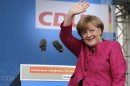 German Chancellor Merkel waves to supporters during a CDU election campaign rally in Stralsund