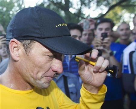 Photo: Lance Armstrong walks back to his car after running at Mount Royal park with fans in Montreal . 