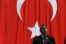 Turkish Foreign Minister Mevlut Cavusoglu delivers a speech during a ceremony in honour of the Portuguese policeman and a Turkish citizen who were victims of an attack on the Turkish embassy in Lisbon by an Armenian group in 1983, in Lisbon, Monday, July 27, 2015. (AP Photo/Francisco Seco)
