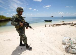A Philippine soldier patrols a beach on Pagasa Island&nbsp;&hellip;