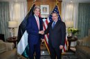 U.S. Secretary of State Kerry shakes hands with Jordanian FM Judeh during a meeting at a hotel in Amman