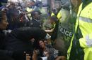 Protestors scuffle with police during a protest at the Ferguson Police Department in Ferguson