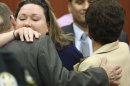 The wife of George Zimmerman, Shellie Zimmerman, left, hugs Robert Zimmerman Sr. and Gladys Zimmerman after Zimmerman's not guilty verdict was read in Seminole Circuit Court in Sanford, Fla. on Saturday, July 13, 2013. Jurors found Zimmerman not guilty of second-degree murder in the fatal shooting of 17-year-old Trayvon Martin in Sanford, Fla. (AP Photo/Gary W. Green, Pool)