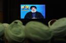 FILE- In this Tuesday, Feb. 16, 2016 file photo, Shiite and Sunni clerics listen to Hezbollah leader Sayyed Hassan Nasrallah as he speaks via a video link, during a ceremony to honer fallen Hezbollah leaders, in the southern suburbs of Beirut, Lebanon. A Saudi-led bloc of six Gulf Arab nations formally branded Hezbollah a terrorist organization on Wednesday, ramping up the pressure on the Lebanese militant group fighting on the side of President Bashar Assad in Syria. (AP Photo/Bilal Hussein, File)