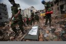 A stretcher with a body bag is placed on standby while workers toil in the collapsed garment factory building Tuesday April 30, 2013 in Savar, near Dhaka, Bangladesh. Emergency workers hauling large concrete slabs from a collapsed 8-story building said Tuesday they expect to find many dead bodies when they reach the ground floor, indicating the death toll will be far more than the official 386. One estimate said it could be as high as 1,400. The illegally constructed, 8-story Rana Plaza collapsed on the morning of April 24, bringing down the five garment factories inside.(AP Photo/Wong Maye-E)