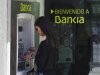 A woman uses a Bankia bank automated teller machine (ATM) in Madrid