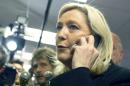 French far-right leader and National Front Party, Marine Le Pen speaks on the phone after a news conference at party headquarters, Sunday, March 22, 2015, in Nanterre, western France. For Le Pen, today's election for more than 2,000 local councils is an important step in building a grassroots base critical to her ultimate goal: the 2017 presidency. Local elections takes place today and the second round on March 29. (AP Photo/Jacques Brinon)