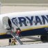 Passengers board a Ryanair plane parked at Girona airport