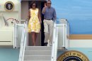 President Barack Obama and first lady Michelle Obama arrive at the Cape Cod Coast Guard Station in Bourne, Mass., Saturday, Aug. 10, 2013, en route to a family vacation on Martha's Vineyard. (AP Photo/Stew Milne)