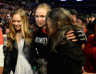 Ronda Rousey leaves the arena with sister Julia De Mars and mother AnnMaria De Mars after her win. (USAT)