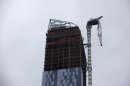 A partially collapsed crane hangs from a high-rise building in Manhattan as Hurricane Sandy makes its approach in New York