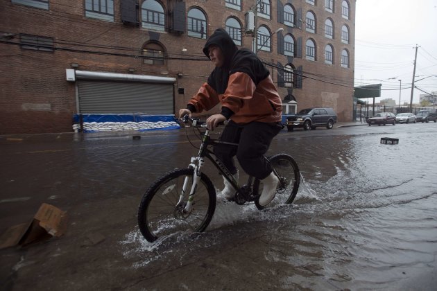 A man makes his way through flood waters in the Red Hook neighborhood of Brooklyn in New York